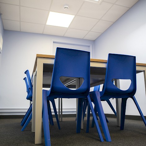 Desk with bright blue chairs for Canterbury Academy School.