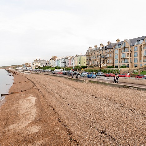 Seafront feature of 41 Central Parade property with sea, sand, on-street parking outside the front of the property.