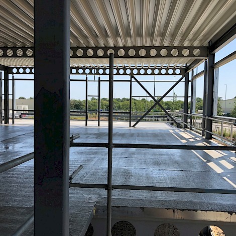 Looking through DOKA headquarters structure showing metal beams and lintels