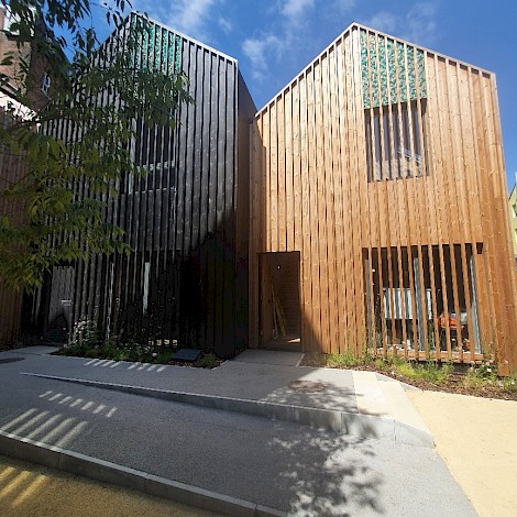 Folkestone art huts in half shade showing wooden outer cladding design